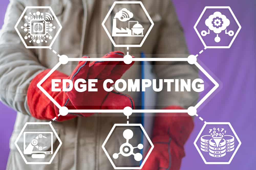 An industrial worker selecting an illustration of distributed edge computing concepts surrounding the word edge computing