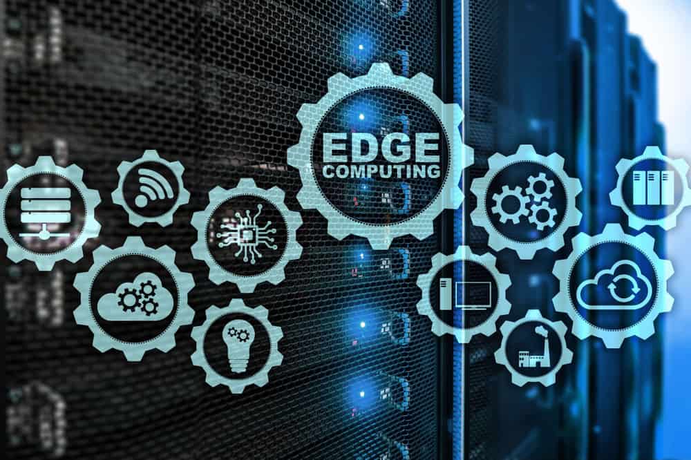 Interlocking cogwheels containing icons of various edge computing examples are displayed in front of racks of servers