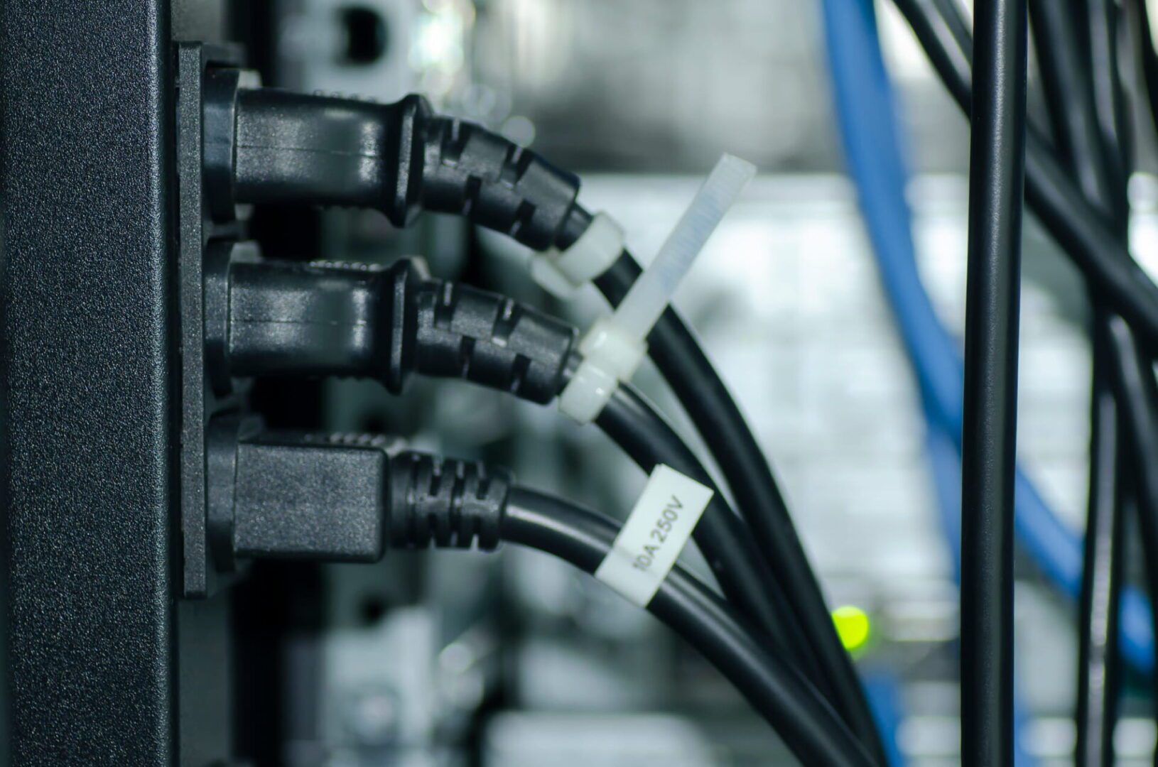 A close-up photo of power cables in a data center rack.